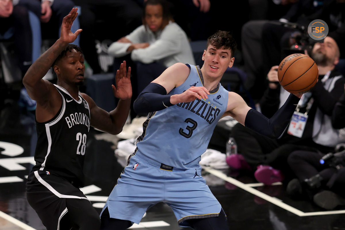 Nov 4, 2024; Brooklyn, New York, USA; Memphis Grizzlies forward Jake LaRavia (3) looks to pass the ball against Brooklyn Nets forward Dorian Finney-Smith (28) during the third quarter at Barclays Center. Credit: Brad Penner-Imagn Images