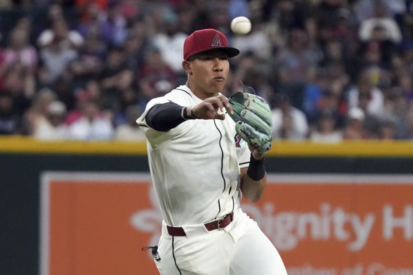 Mar 31, 2026; Phoenix, Arizona, USA; Arizona Diamondbacks third baseman Jose Fernandez (11) makes the off balance throw for an out against the Detroit Tigers in the first inning at Chase Field. Mandatory Credit: Rick Scuteri-Imagn Images