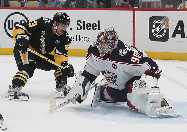 Jan 7, 2025; Pittsburgh, Pennsylvania, USA; Columbus Blue Jackets goaltender Elvis Merzlikins (90) defends the net against Pittsburgh Penguins left wing Matt Nieto (83) during the first period at PPG Paints Arena. Credit: Charles LeClaire-Imagn Images