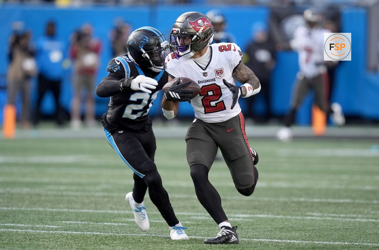 Dec 21, 2025; Charlotte, North Carolina, USA; Tampa Bay Buccaneers wide receiver Emeka Egbuka (2) runs against Carolina Panthers safety Nick Scott (21) during the second half at Bank of America Stadium. Credit: Jim Dedmon-Imagn Images