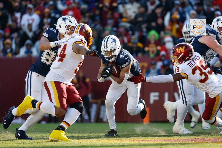 Dec 25, 2025; Landover, Maryland, USA; Dallas Cowboys running back Malik Davis (43) carries the ball defended by Washington Commanders safety Jeremy Reaves (39) in the first half at Northwest Stadium. Credit: Amber Searls-Imagn Images