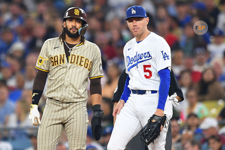 LOS ANGELES, CA - SEPTEMBER 13: San Diego Padres right fielder Fernando Tatis Jr. (23) looks on with Los Angeles Dodgers first baseman Freddie Freeman (5) during the MLB game between the San Diego Padres and the Los Angeles Dodgers on September 13, 2023 at Dodger Stadium in Los Angeles, CA. (Photo by Brian Rothmuller/Icon Sportswire)