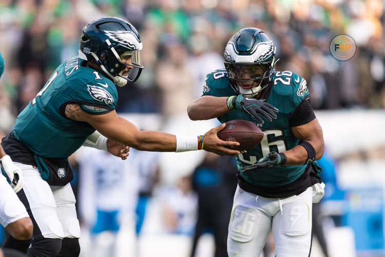 Dec 8, 2024; Philadelphia, Pennsylvania, USA; Philadelphia Eagles quarterback Jalen Hurts (1) hands off to running back Saquon Barkley (26) during the third quarter against the Carolina Panthers at Lincoln Financial Field. Credit: Bill Streicher-Imagn Images