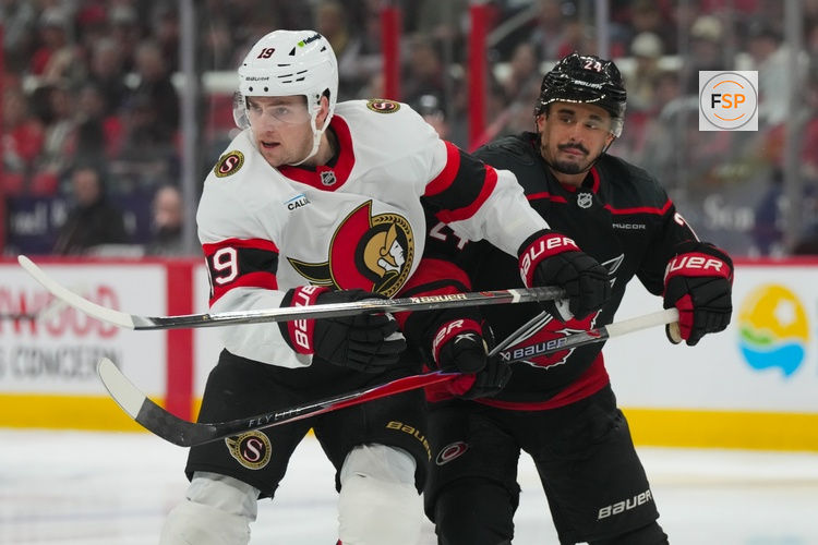 Apr 20, 2026; Raleigh, North Carolina, USA; Carolina Hurricanes center Seth Jarvis (24) and Ottawa Senators right wing Drake Batherson (19) battle in the first overtime period in game two of the first round of the 2026 Stanley Cup Playoffs at Lenovo Center. Credit: James Guillory-Imagn Images