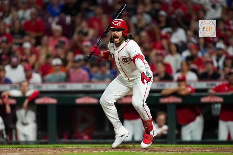Aug 4, 2026; Cincinnati, Ohio, USA;  Cincinnati Reds designated hitter Eugenio Suarez reacts to first baseman Sal Stewart after a wild pitch against the Athletics in the eighth inning at Great American Ball Park. Credit: Aaron Doster-Imagn Images