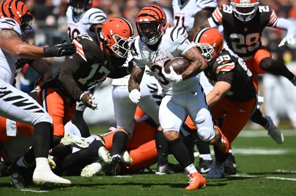 Sep 7, 2025; Cleveland, Ohio, USA; Cincinnati Bengals running back Chase Brown (30) runs against Cleveland Browns linebacker Jerome Baker (17) during the first quarter at Huntington Bank Field. Mandatory Credit: Ken Blaze-Imagn Images