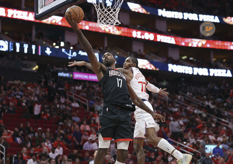 Nov 15, 2024; Houston, Texas, USA; Houston Rockets forward Tari Eason (17) shoots the ball as Los Angeles Clippers guard Kevin Porter Jr. (77) defends during the fourth quarter at Toyota Center. Credit: Troy Taormina-Imagn Images