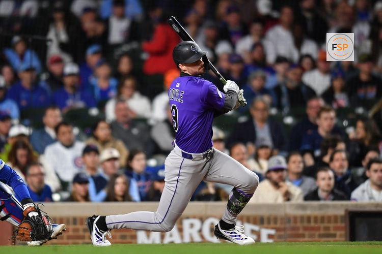 May 27, 2025; Chicago, Illinois, USA; Colorado Rockies center fielder Brenton Doyle (9) hits a sacrifice RBI ground out during the eleventh inning against the Chicago Cubs at Wrigley Field. Credit: Patrick Gorski-Imagn Images