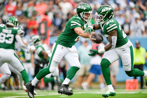 Sep 15, 2024; Nashville, Tennessee, USA;  New York Jets quarterback Aaron Rodgers (8) hands the ball to running back Breece Hall (20) against the Tennessee Titans during the first half at Nissan Stadium. Mandatory Credit: Steve Roberts-Imagn Images