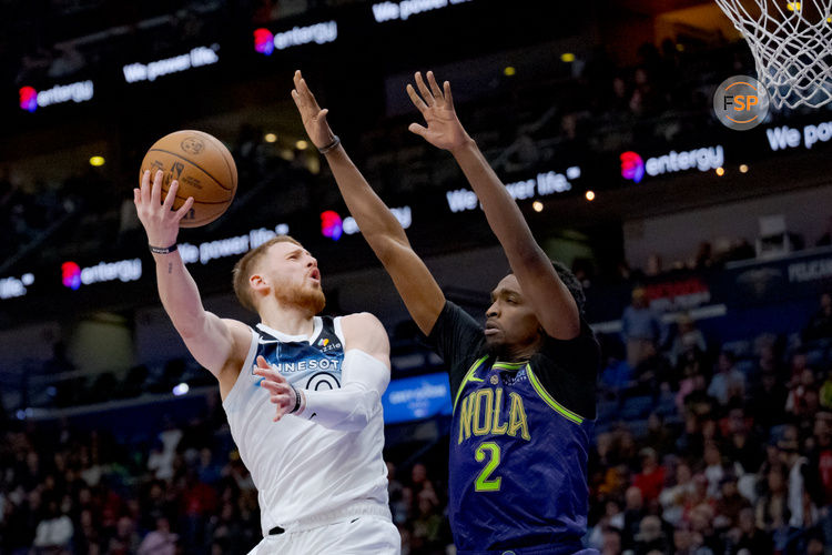 Jan 7, 2025; New Orleans, Louisiana, USA; Minnesota Timberwolves guard Donte DiVincenzo (0) shoots against New Orleans Pelicans forward Herbert Jones (2) during the second half at Smoothie King Center. Credit: Matthew Hinton-Imagn Images