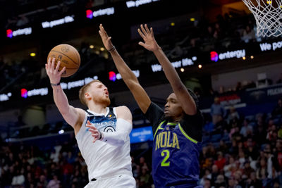 Jan 7, 2025; New Orleans, Louisiana, USA; Minnesota Timberwolves guard Donte DiVincenzo (0) shoots against New Orleans Pelicans forward Herbert Jones (2) during the second half at Smoothie King Center. Mandatory Credit: Matthew Hinton-Imagn Images