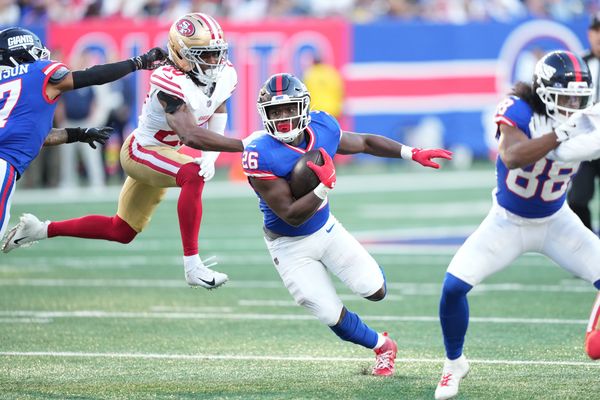 Nov 2, 2025; East Rutherford, New Jersey, USA; New York Giants running back Devin Singletary (26) carries the ball as San Francisco 49ers cornerback Upton Stout (20) pursues during the second half at MetLife Stadium. Mandatory Credit: Robert Deutsch-Imagn Images