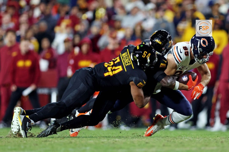 Oct 27, 2024; Landover, Maryland, USA; Chicago Bears tight end Cole Kmet (85) catches a pass against Washington Commanders linebacker Bobby Wagner (54) during the fourth quarter at Commanders Field. Credit: Peter Casey-Imagn Images