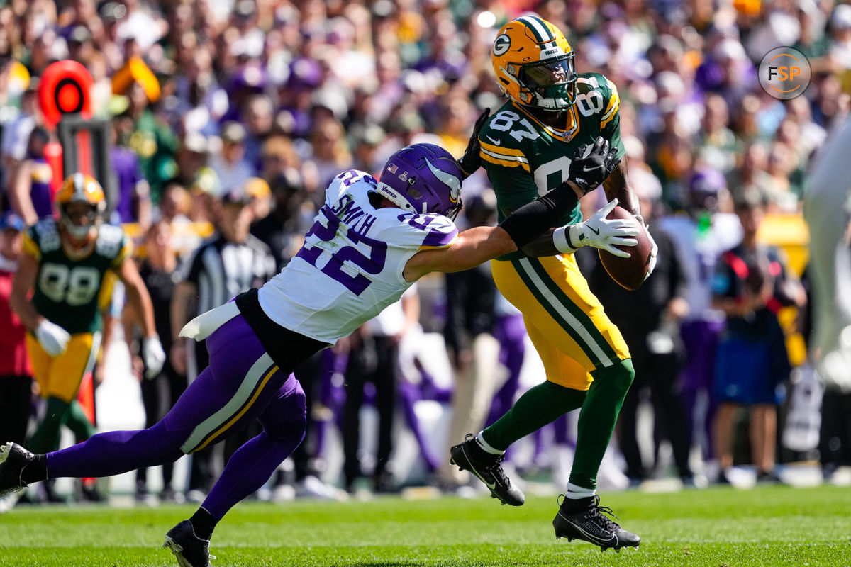 Sep 29, 2024; Green Bay, Wisconsin, USA;  Minnesota Vikings safety Harrison Smith (22) breaks up the pass intended for Green Bay Packers wide receiver Romeo Doubs (87) during the second quarter at Lambeau Field. Credit: Jeff Hanisch-Imagn Images