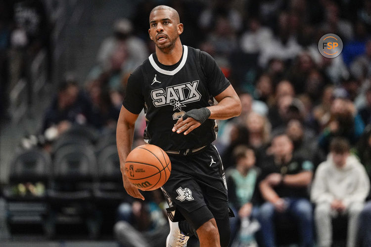 Feb 7, 2025; Charlotte, North Carolina, USA;  San Antonio Spurs guard Chris Paul (3) brings the ball up court against the Charlotte Hornets during the second half at Spectrum Center. Credit: Jim Dedmon-Imagn Images