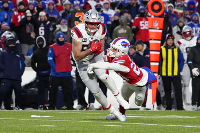 Dec 22, 2024; Orchard Park, New York, USA; New England Patriots tight end Hunter Henry (85) breaks a tackle attempt by Buffalo Bills safety Cole Bishop (24) after making a catch during the first half at Highmark Stadium. Mandatory Credit: Gregory Fisher-Imagn Images