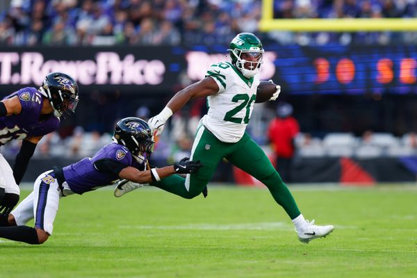Nov 23, 2025; Baltimore, Maryland, USA;  New York Jets running back Breece Hall (20) rushes as Baltimore Ravens cornerback Nate Wiggins (2) defends during the fourth quarter at M&T Bank Stadium. Mandatory Credit: Peter Casey-Imagn Images