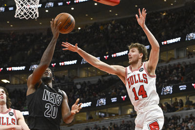 Dec 2, 2024; Chicago, Illinois, USA;  Brooklyn Nets center Day'Ron Sharpe (20) shoots against Chicago Bulls forward Matas Buzelis (14) during the second half at the United Center. Mandatory Credit: Matt Marton-Imagn Images