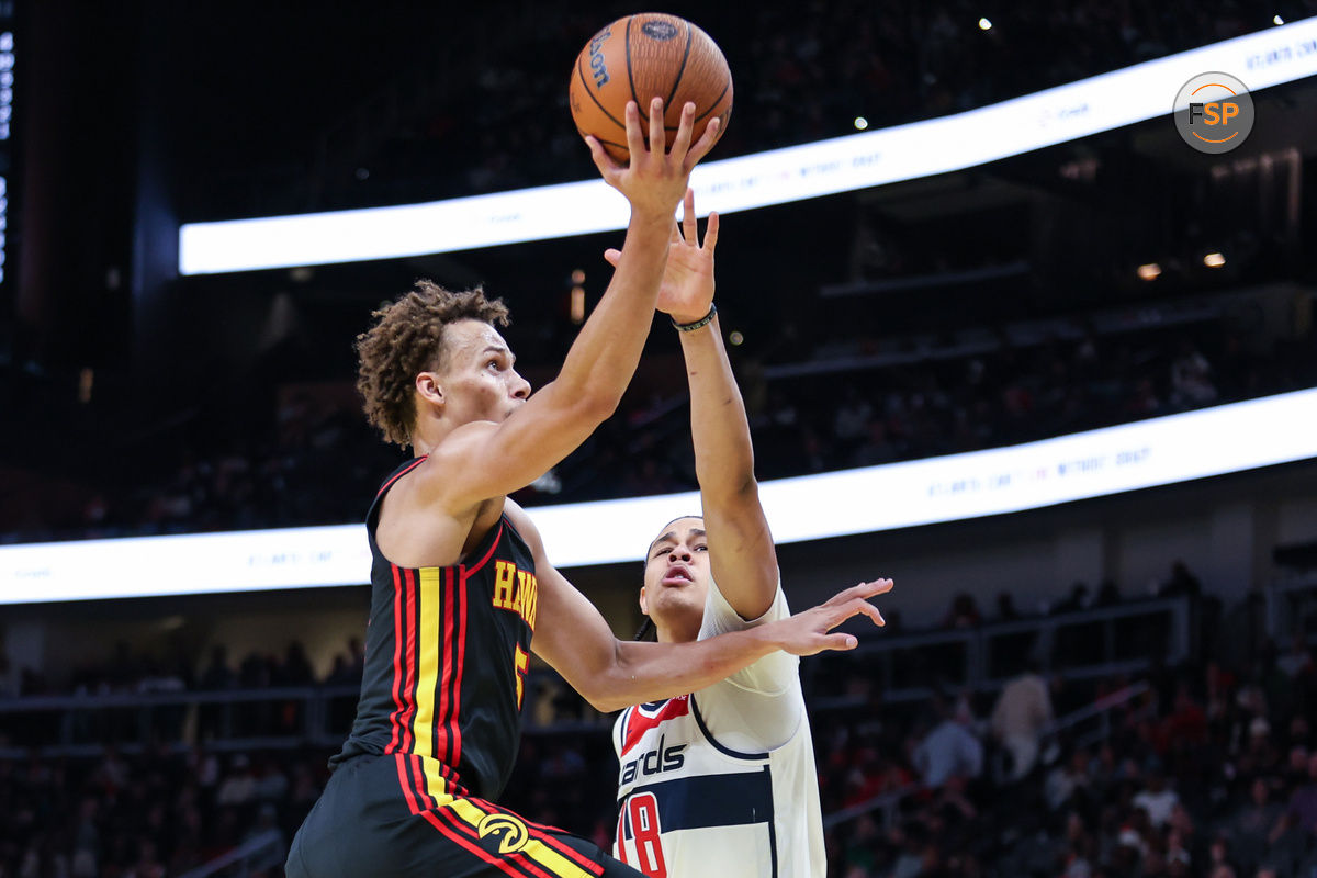 Nov 15, 2024; Atlanta, Georgia, USA; Atlanta Hawks guard Dyson Daniels (5) shoots the ball against Washington Wizards forward Kyshawn George (18) during the third quarter at State Farm Arena. Credit: Jordan Godfree-Imagn Images