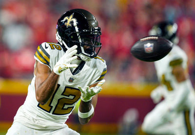 Oct 7, 2024; Kansas City, Missouri, USA; New Orleans Saints wide receiver Chris Olave (12) catches a pass during the second half against the Kansas City Chiefs at GEHA Field at Arrowhead Stadium. Mandatory Credit: Jay Biggerstaff-Imagn Images