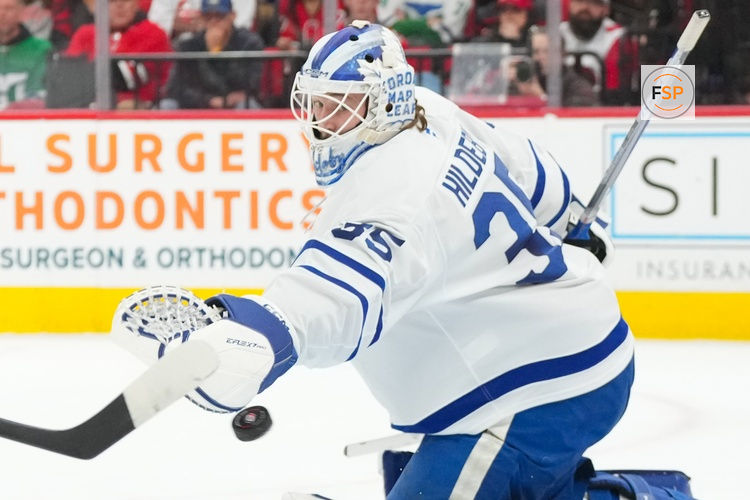 Dec 4, 2025; Raleigh, North Carolina, USA; Toronto Maple Leafs goaltender Dennis Hildeby (35) reaches out for the shot against the Carolina Hurricanes during the third period at Lenovo Center. Credit: James Guillory-Imagn Images