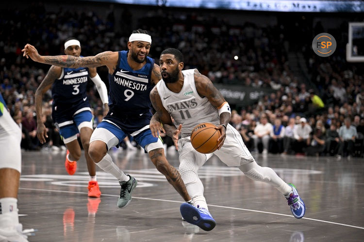 Jan 22, 2025; Dallas, Texas, USA; Dallas Mavericks guard Kyrie Irving (11) drives to the basket past Minnesota Timberwolves guard Nickeil Alexander-Walker (9) during the second half at the American Airlines Center. Credit: Jerome Miron-Imagn Images