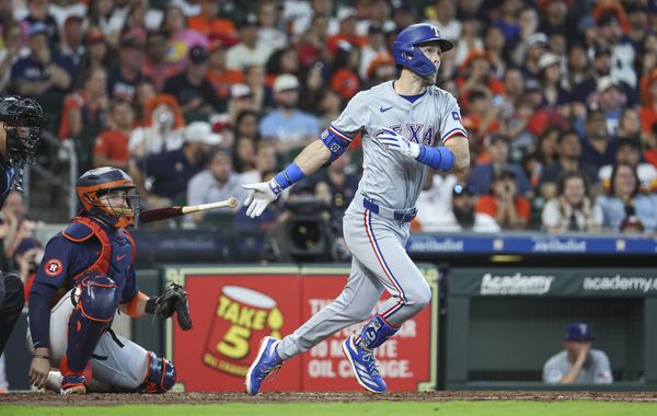 Apr 14, 2024; Houston, Texas, USA; Texas Rangers left fielder Evan Carter (32) hits a home run during the fourth inning against the Houston Astros at Minute Maid Park. Mandatory Credit: Troy Taormina-USA TODAY Sports