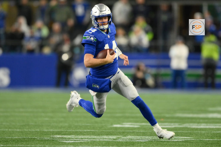 Oct 25, 2026; Seattle, Washington, USA;  Seattle Seahawks quarterback Sam Darnold (14) scrambles with the ball against the Kansas City Chiefs during the second quarter at Lumen Field.  Credit: Steven Bisig-Imagn Images