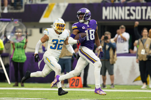 MINNEAPOLIS, MN - SEPTEMBER 24: Minnesota Vikings wide receiver Justin Jefferson (18) runs for a touchdown while being chased by Los Angeles Chargers safety Alohi Gilman (32) during the NFL game between the Los Angles Chargers and the Minnesota Vikings on September 24th, 2023, at U.S. Bank Stadium in Minneapolis, MN. (Photo by Bailey Hillesheim/Icon Sportswire)