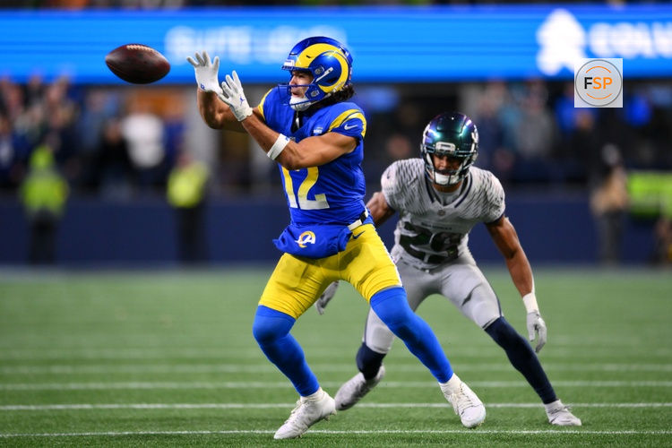 Dec 18, 2025; Seattle, Washington, USA; Los Angeles Rams wide receiver Puka Nacua (12) makes a catch against Seattle Seahawks cornerback Josh Jobe (29) in overtime at Lumen Field. Credit: Steven Bisig-Imagn Images