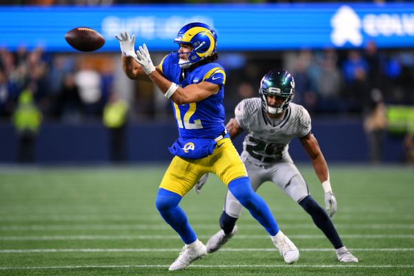 Dec 18, 2025; Seattle, Washington, USA; Los Angeles Rams wide receiver Puka Nacua (12) makes a catch against Seattle Seahawks cornerback Josh Jobe (29) in overtime at Lumen Field. Mandatory Credit: Steven Bisig-Imagn Images