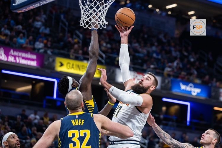 Dec 3, 2025; Indianapolis, Indiana, USA; Denver Nuggets center Jonas Valanciunas (17) shoots the ball while Indiana Pacers forward Pascal Siakam (43)  defends in the first  half at Gainbridge Fieldhouse. Credit: Trevor Ruszkowski-Imagn Images