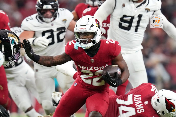 Arizona Cardinals running back Michael Carter (22) breaks out of the backfield against the Jacksonville Jaguars at State Farm Stadium on Nov. 23, 2025.