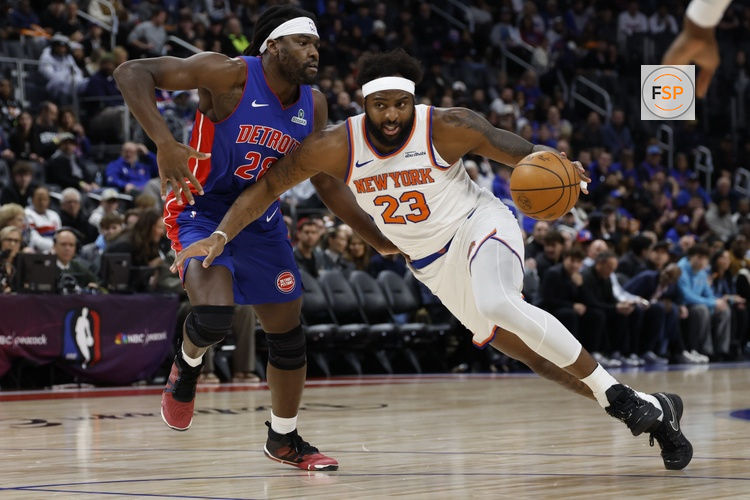 Jan 5, 2026; Detroit, Michigan, USA;  New York Knicks center Mitchell Robinson (23) dribbles on Detroit Pistons forward Isaiah Stewart (28) in the first half at Little Caesars Arena. Credit: Rick Osentoski-Imagn Images