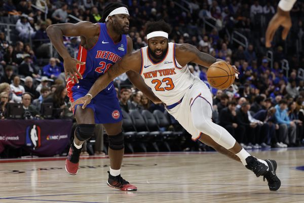 Jan 5, 2026; Detroit, Michigan, USA;  New York Knicks center Mitchell Robinson (23) dribbles on Detroit Pistons forward Isaiah Stewart (28) in the first half at Little Caesars Arena. Mandatory Credit: Rick Osentoski-Imagn Images