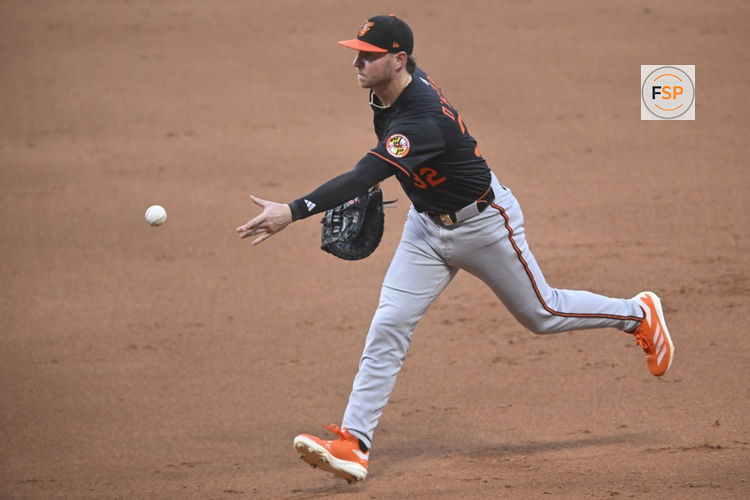 Jul 21, 2025; Cleveland, Ohio, USA; Baltimore Orioles first baseman Ryan O'Hearn (32) tosses the ball to first base in the fifth inning against the Cleveland Guardians at Progressive Field. Credit: David Richard-Imagn Images