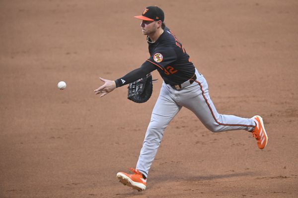 Jul 21, 2025; Cleveland, Ohio, USA; Baltimore Orioles first baseman Ryan O'Hearn (32) tosses the ball to first base in the fifth inning against the Cleveland Guardians at Progressive Field. Mandatory Credit: David Richard-Imagn Images