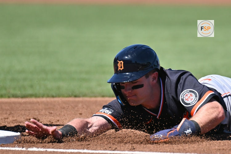 Feb 24, 2026; North Port, Florida, USA; Detroit Tigers shortstop Kevin McGonigle (85) dives back to first base in the first inning against the Atlanta Braves during spring training at CoolToday Park. Credit: Jonathan Dyer-Imagn Images