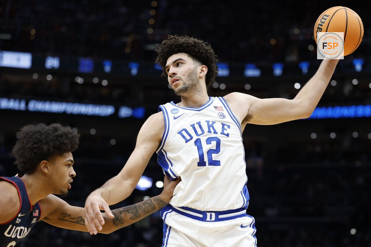 Mar 29, 2026; Washington, DC, USA; Duke Blue Devils forward Cameron Boozer (12) grabs the ball in front of UConn Huskies forward Jaylin Stewart (3) in the first half during an Elite Eight game of the East Regional of the men's 2026 NCAA Tournament at Capital One Arena. Credit: Amber Searls-Imagn Images