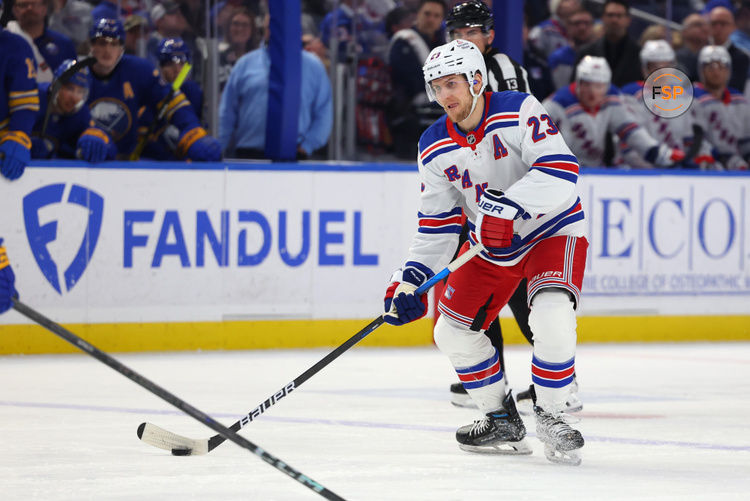 Feb 22, 2025; Buffalo, New York, USA;  New York Rangers defenseman Adam Fox (23) looks to make a pass during the third period against the Buffalo Sabres at KeyBank Center. Credit: Timothy T. Ludwig-Imagn Images