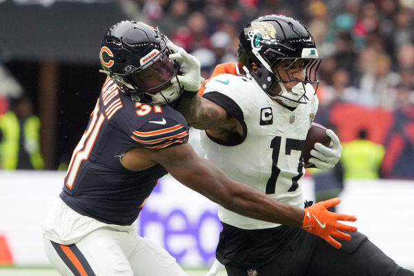 Oct 13, 2024; London, United Kingdom; Jacksonville Jaguars tight end Evan Engram (17) carries the ball against Chicago Bears safety Kevin Byard III (31) in the second half during an NFL International Series game at Tottenham Hotspur Stadium. Mandatory Credit: Kirby Lee-Imagn Images