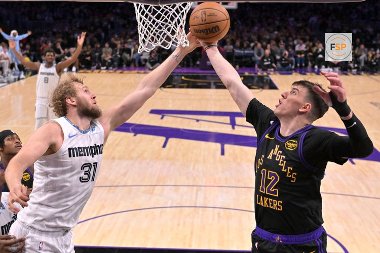 Jan 2, 2026; Los Angeles, California, USA; Memphis Grizzlies center Jock Landale (31) and Los Angeles Lakers forward Jake Laravia (12) reach for a rebound in the second half at Crypto.com Arena. Credit: Jayne Kamin-Oncea-Imagn Images