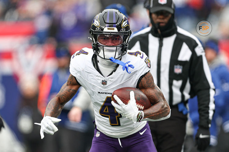 Dec 15, 2024; East Rutherford, New Jersey, USA; Baltimore Ravens wide receiver Zay Flowers (4) carries the ball against the New York Giants during the first quarter at MetLife Stadium. Credit: Vincent Carchietta-Imagn Images