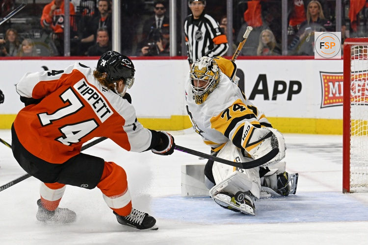 Apr 22, 2026; Philadelphia, Pennsylvania, USA; Pittsburgh Penguins goaltender Stuart Skinner (74) makes a save against Philadelphia Flyers right wing Owen Tippett (74) during the third period in game three of the first round of the 2026 Stanley Cup Playoffs at Xfinity Mobile Arena. Credit: Eric Hartline-Imagn Images