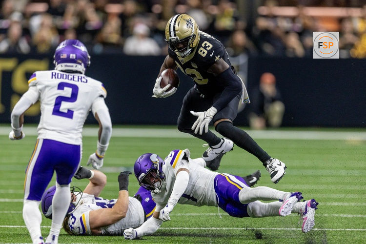 Oct 11, 2026; New Orleans, Louisiana, USA;  New Orleans Saints tight end Juwan Johnson (83) leaps over Minnesota Vikings outside linebacker Andrew van Ginkel (43) and cornerback Byron Murphy (7) during the second half at Caesars Superdome.  Credit: Stephen Lew-Imagn Images