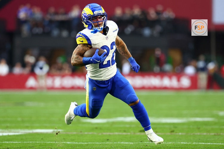 Dec 7, 2025; Glendale, Arizona, USA; Los Angeles Rams running back Blake Corum (22) rushes the ball against the Arizona Cardinals during the first half at State Farm Stadium. Credit: Mark J. Rebilas-Imagn Images