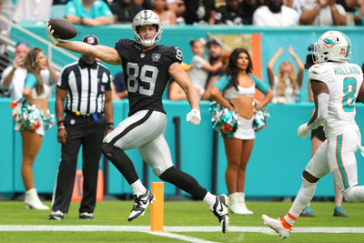 Nov 17, 2024; Miami Gardens, Florida, USA; Las Vegas Raiders tight end Brock Bowers (89) scores a touchdown past Miami Dolphins safety Jevon Holland (8) in the third quarter at Hard Rock Stadium. Mandatory Credit: Jim Rassol-Imagn Images