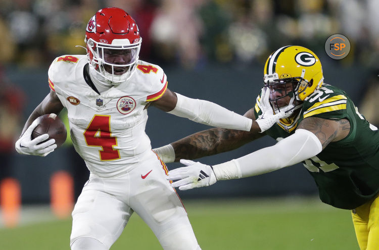 Dec 3, 2023; Green Bay, Wisconsin, USA; Kansas City Chiefs wide receiver Rashee Rice (4) stiff arms Green Bay Packers linebacker Preston Smith (91) during their football game at Lambeau Field. Credit: Dan Powers-USA TODAY Sports