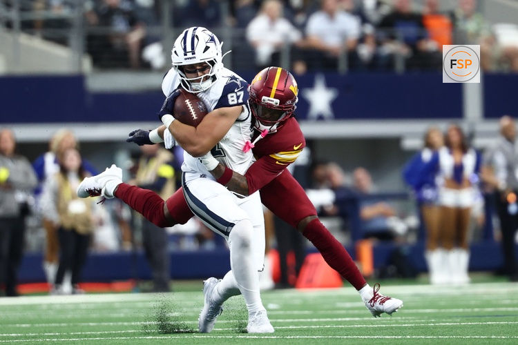 Oct 19, 2025; Arlington, Texas, USA; Dallas Cowboys tight end Jake Ferguson (87) carries the ball defended by Washington Commanders safety Quan Martin (20) during the second quarter of the game at AT&T Stadium. Credit: Kevin Jairaj-Imagn Images
