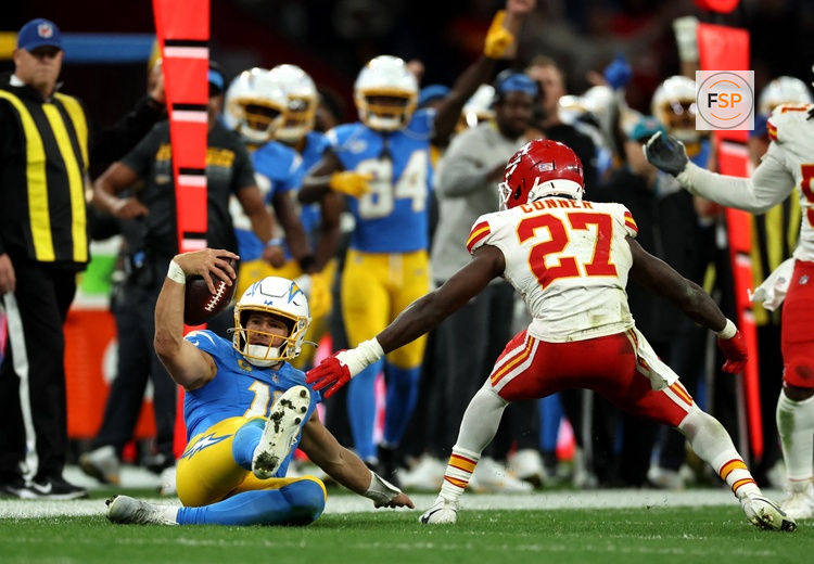 [US, Mexico & Canada customers only] Sep 5, 2025; Sao Paulo, BRAZIL;  Los Angeles Chargers quarterback Justin Herbert (10) picks up a first down against Kansas City Chiefs safety Chamarri Conner (27) during a NFL game at Corinthians Arena. Credit: Amanda Perobelli/Reuters via Imagn Images